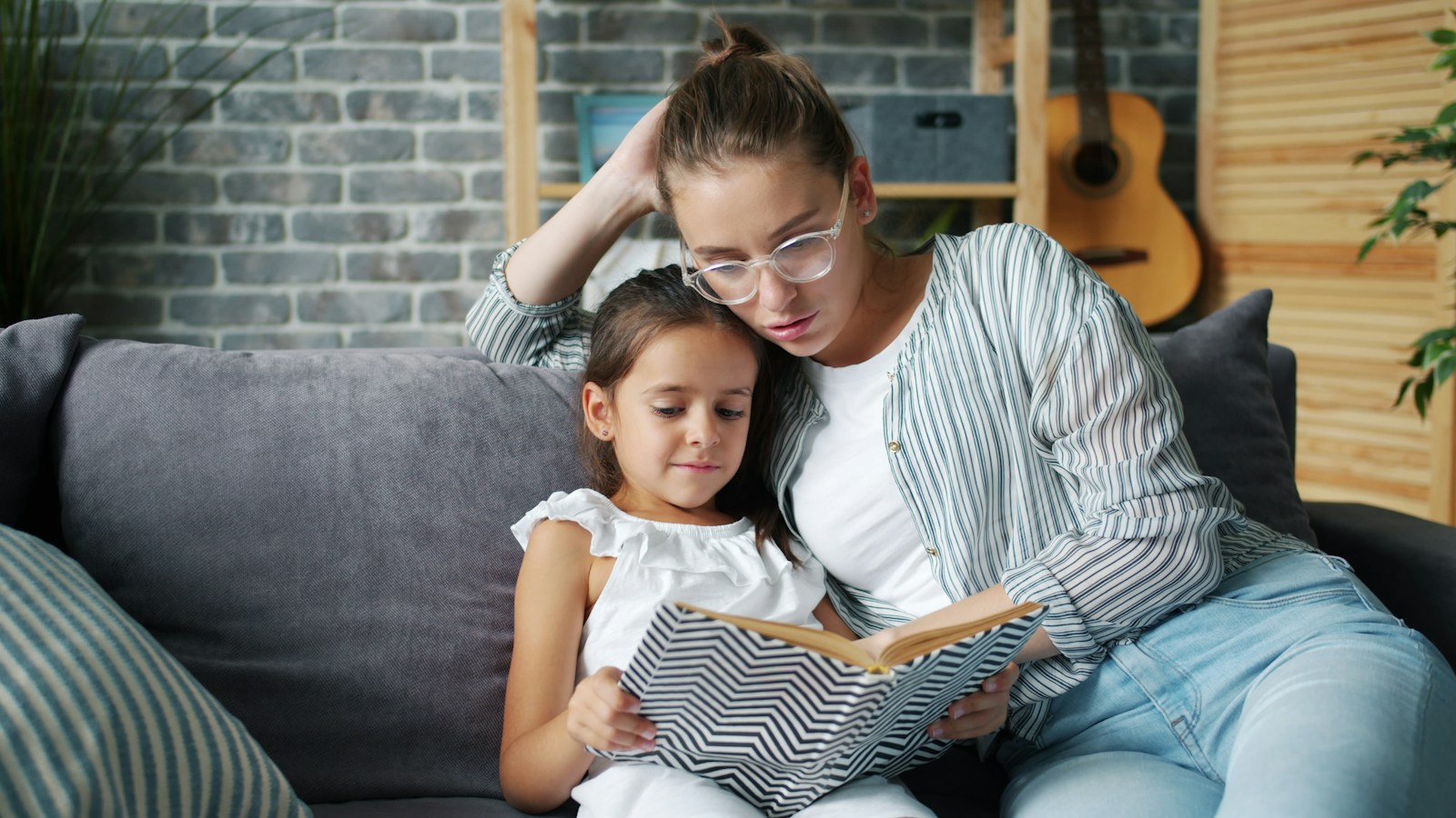 A parent and child reading together at home